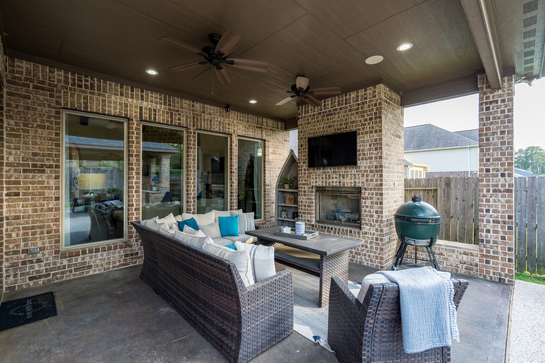 Covered outdoor living room with a fireplace